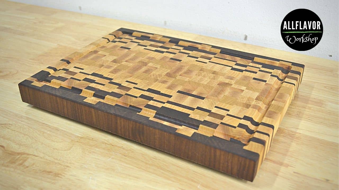 Finished ombré end grain cutting board made from walnut, ash, and beech with handles and a juice groove.