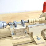 DIY wood lathe made from plywood and powered by a drill for turning small wood parts.