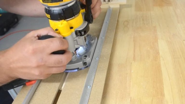 Homemade adjustable router dado jig with aluminum rails and wooden knobs.