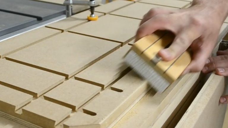 Sanding the top edges of the jointer sled with a sanding block