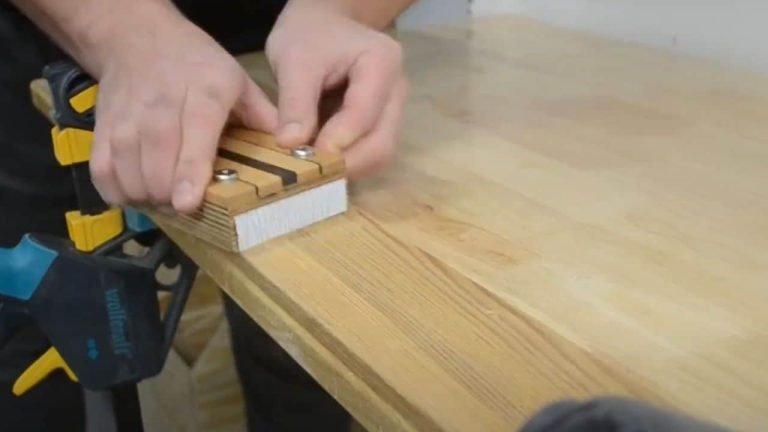 Holding a sanding block with finger grips during edge sanding