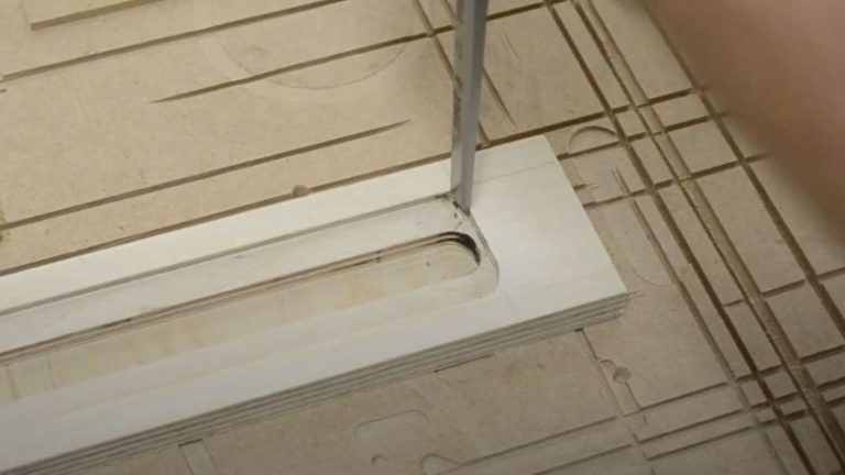Using a chisel to clean up router dado ends on the hexagon jig fence