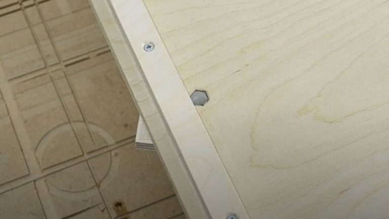 Mounting the hexagon jig fence onto the table saw sled with a bolt and wing nut