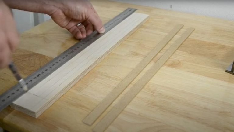 Marking layout lines on the plywood strip with a marking gauge for router dados