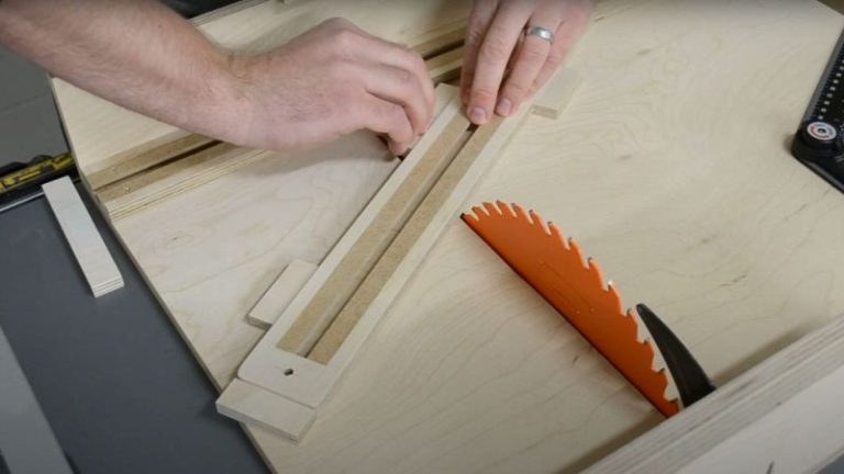 Holding the hexagon jig fence in place on the sled using plywood spacers and double-sided tape