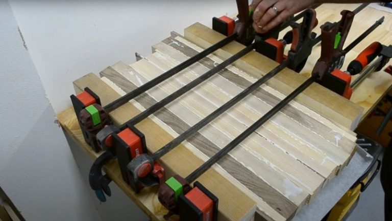 Clamping wood strips with Bessey parallel clamps for edge grain cutting board glue-up.