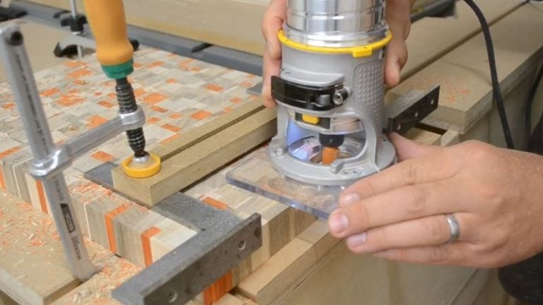 Cutting finger handles on the underside of a cutting board using a router handle jig.