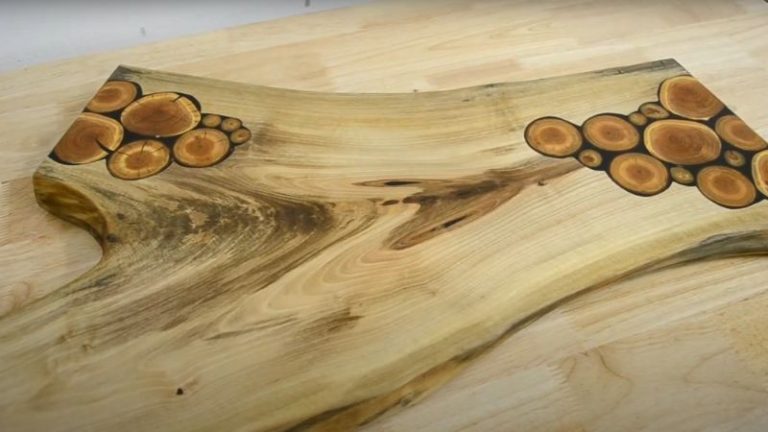 Finished DIY face grain cutting board made from walnut with cherry branch inlays and epoxy details.