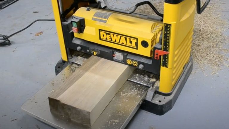 Planing a walnut board after straightening the edges with a jointer sled.