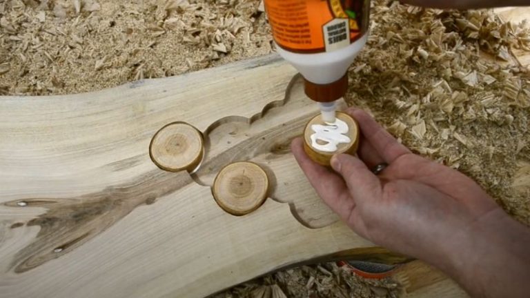 Gluing cherry branch cookies into routed recesses on the walnut board.
