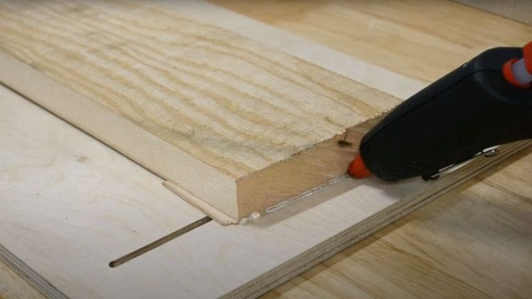 Planing a twisted ash board attached to a larger base board using a glue gun.