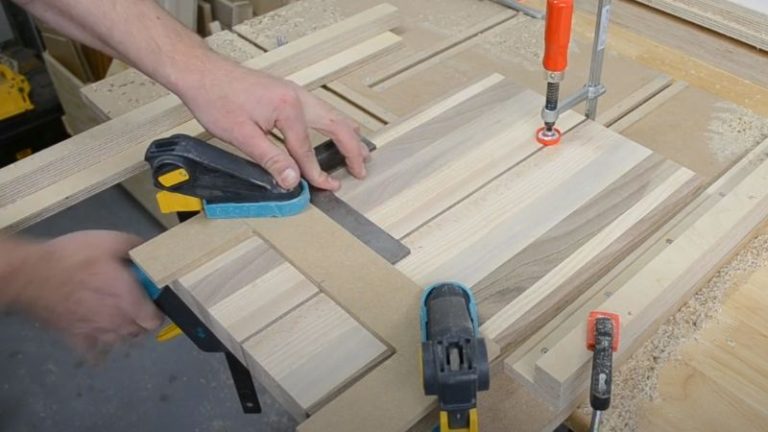 Positioning a router handle jig on the bottom of an edge grain cutting board.