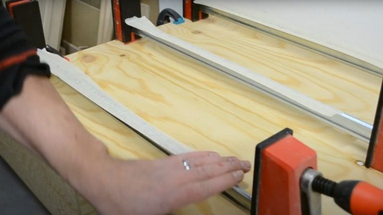 Preparing parallel clamps with masking tape for cutting board glue-up.