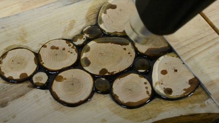 Using a heat gun to remove air bubbles from epoxy resin.