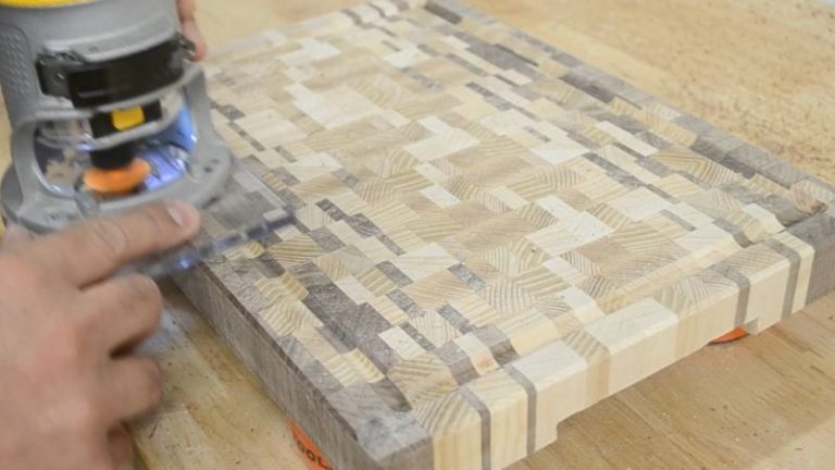 Beveling the edges of an end grain cutting board with a 45-degree router bit.
