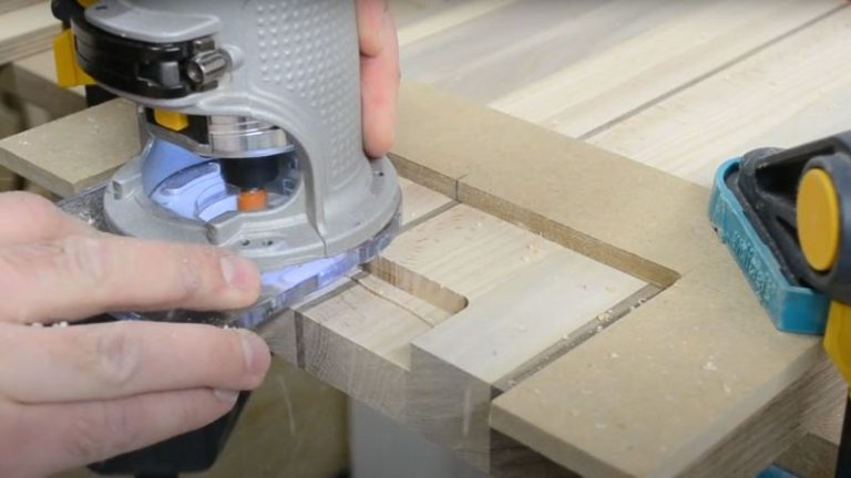 Routing a handle recess with a straight router bit using a handle jig.