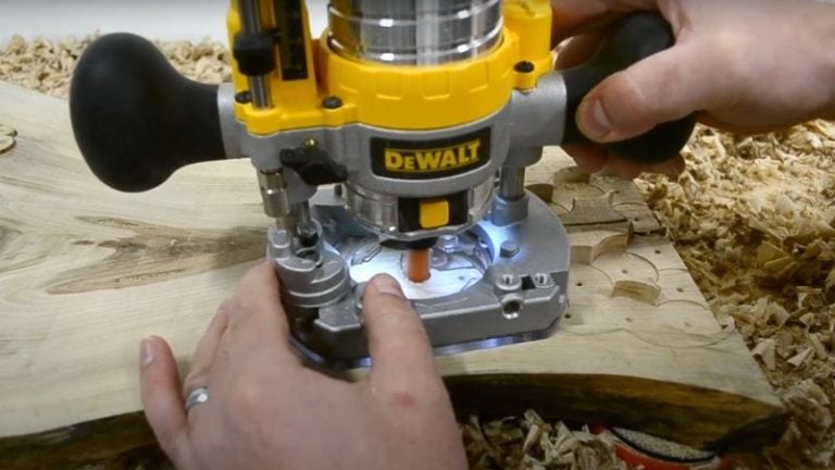 Cleaning recess edges with a trim router and straight router bit.