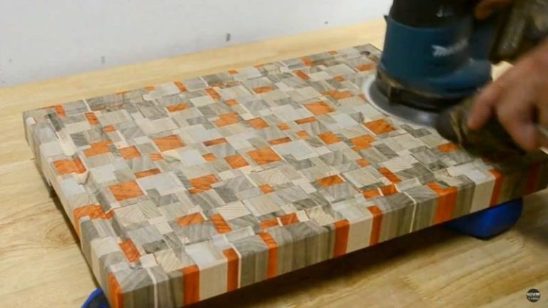 Sanding a chaotic end grain cutting board with an orbital sander from 80 to 300 grit.