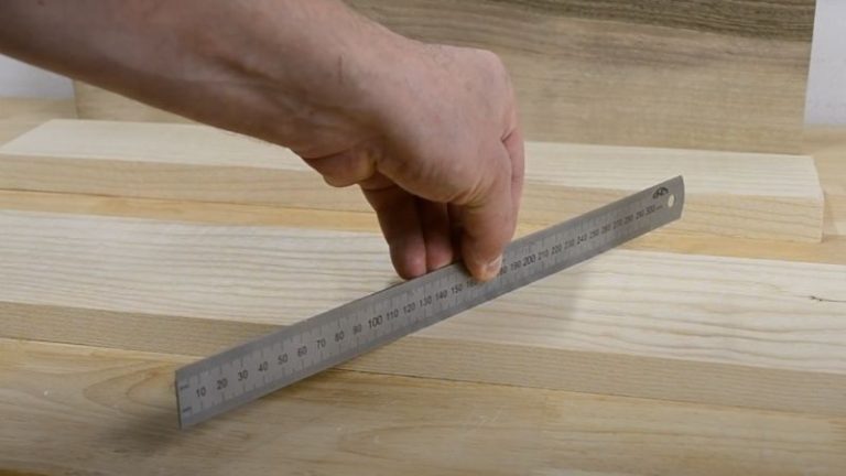 Straightening the edges of a planed ash board using a jointer sled.