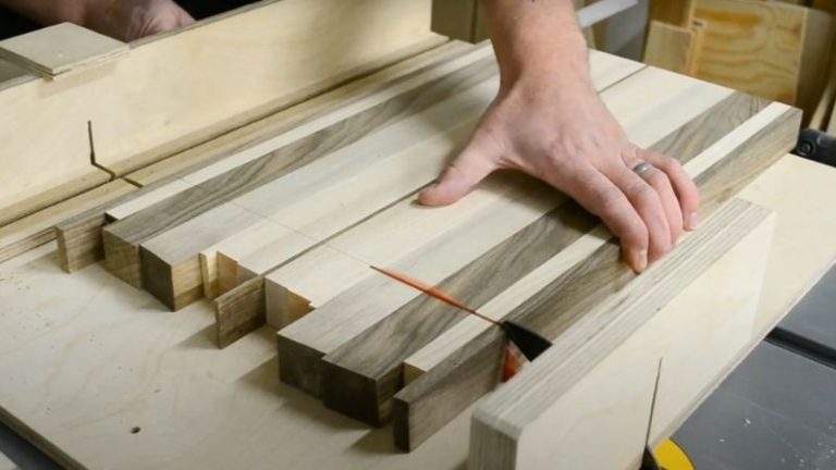 Trimming the ends of a cutting board square using a table saw sled.