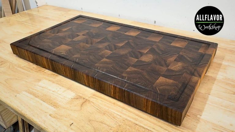 DIY walnut end grain cutting board with juice groove, beveled edges, and rubber feet ready for use.