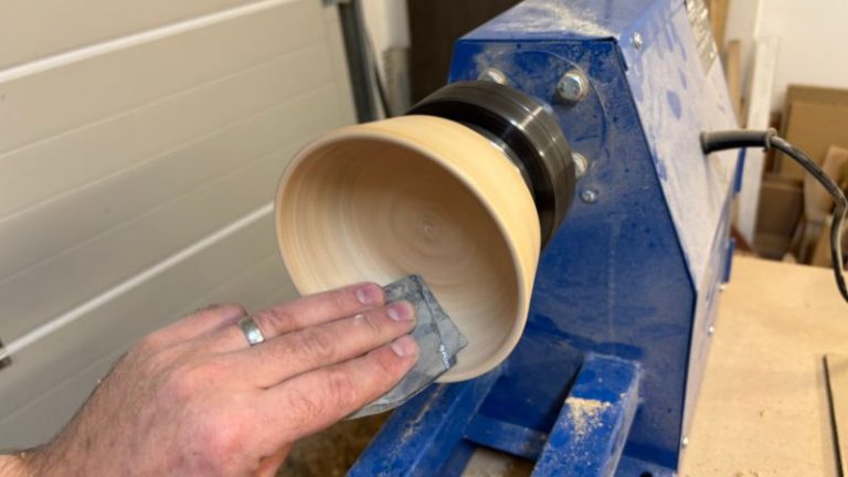 Hand-sanding small swirls and touch-ups on the inside curve of the bowl