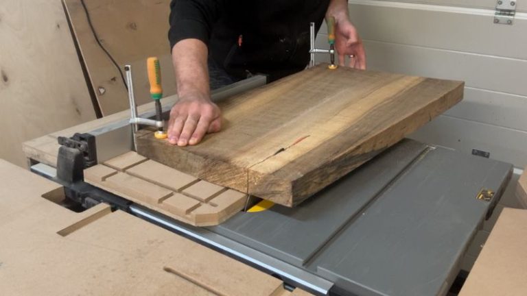 Walnut board clamped on a jointer sled to straighten one edge before planing.