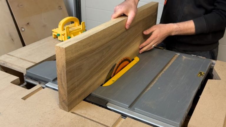 Close-up of a table saw fence being set to the same dimension as the board thickness for cutting walnut strips.