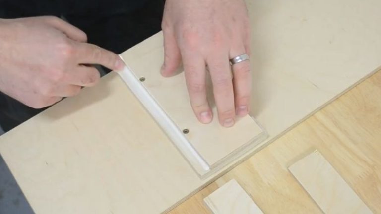 Applying a thin bead of wood glue into the rabbets on the push block base before attaching the side stands.