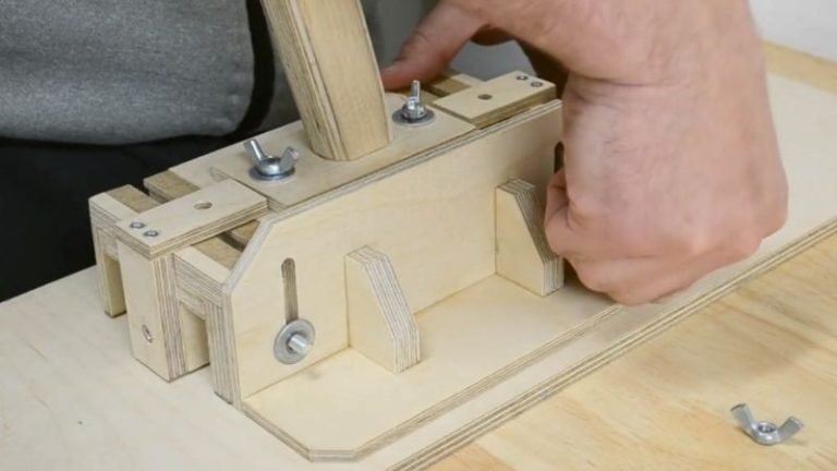 Attaching the adjustable side stand to the push block side leg using bolts and wing nuts.