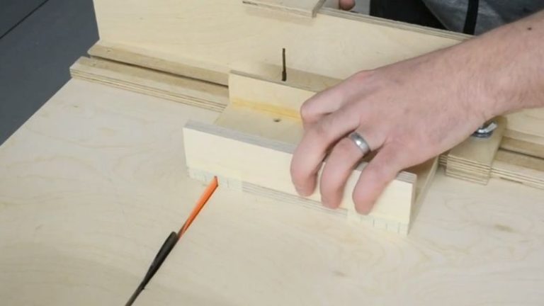 Cutting T-track dados on top of the push block base using a table saw and sled.