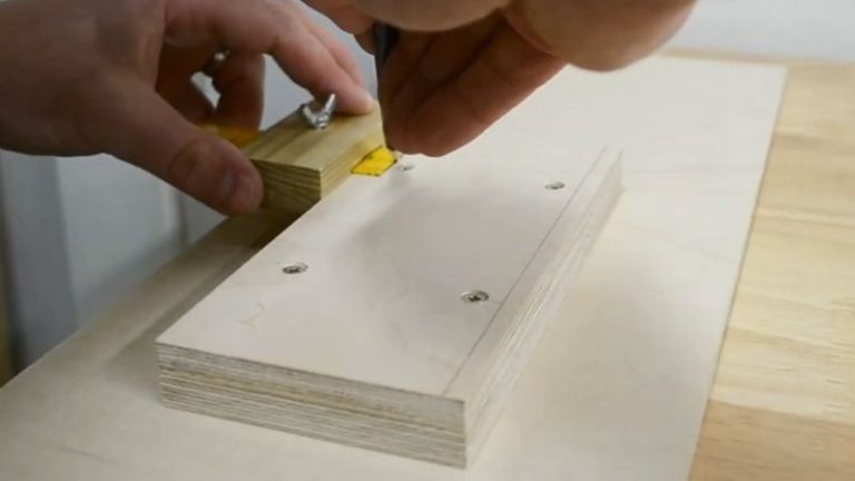 Marking two rabbets on the bottom of the push block base using a ruler marking gauge.