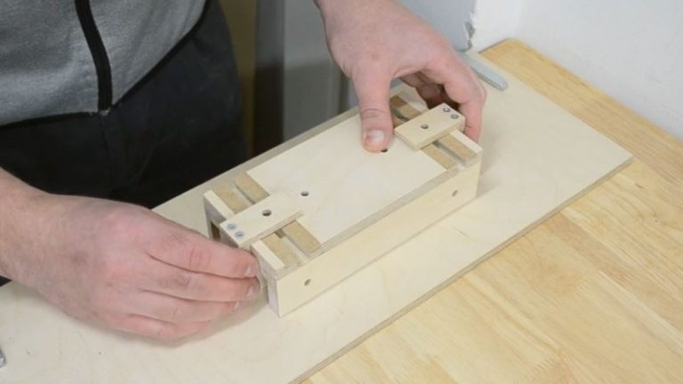 Test-fitting the adjustable center leg over the T-track slots on the push block base.