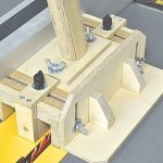 DIY table saw push block with adjustable center leg, side stand, handle, and non-slip rubber base for safe ripping.