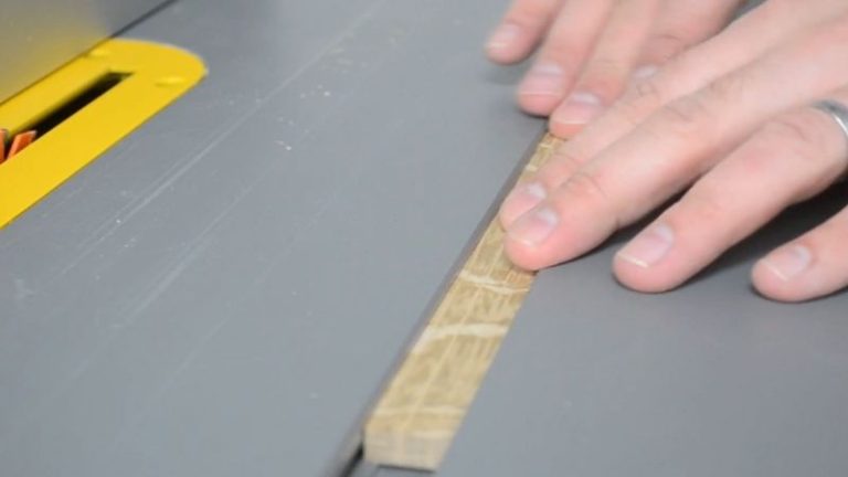 Checking the fit of an oak runner in the table saw miter slot for the picture frame sled.