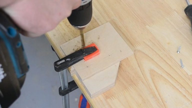 Small plywood connector piece glued and screwed onto the stop block with a drilled hole for a T-track bolt.