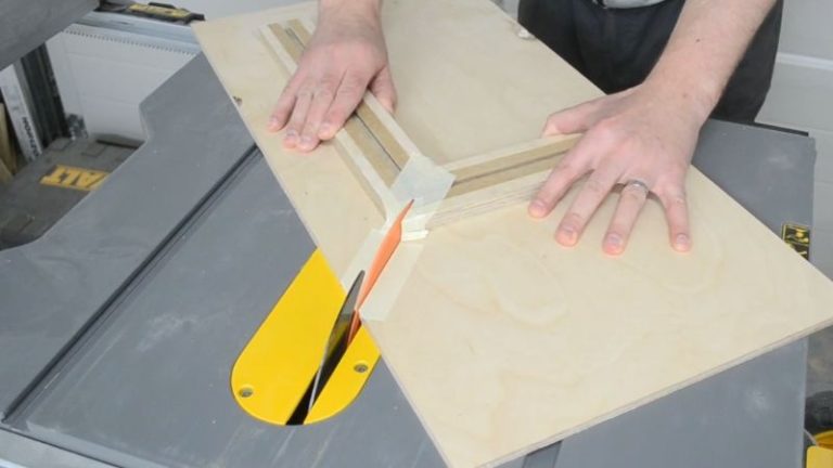 Fences glued to the base at 90 degrees and the first saw kerf cut through the picture frame jig.