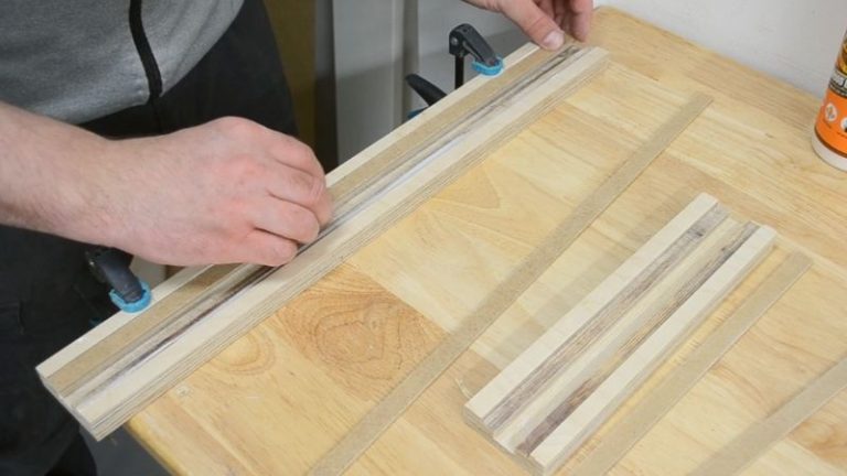 MDF strips being glued into the outer slots of the fence to form a T-track channel.