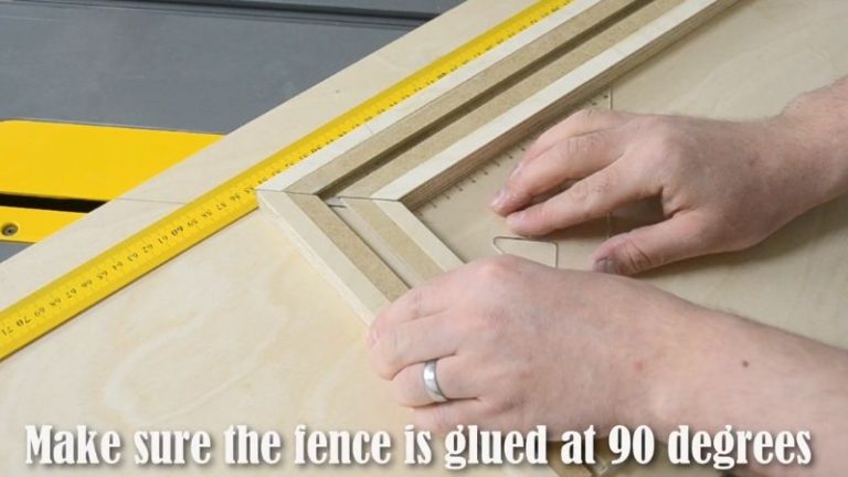 Short fence being glued at 90 degrees to the long fence on the picture frame jig using a square for alignment.