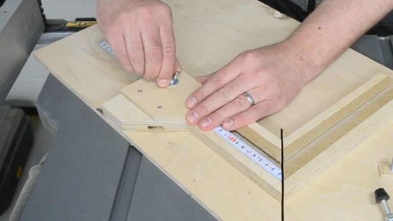 Adjustable stop block mounted in the fence T-track of the picture frame jig using a T-track bolt and knob.