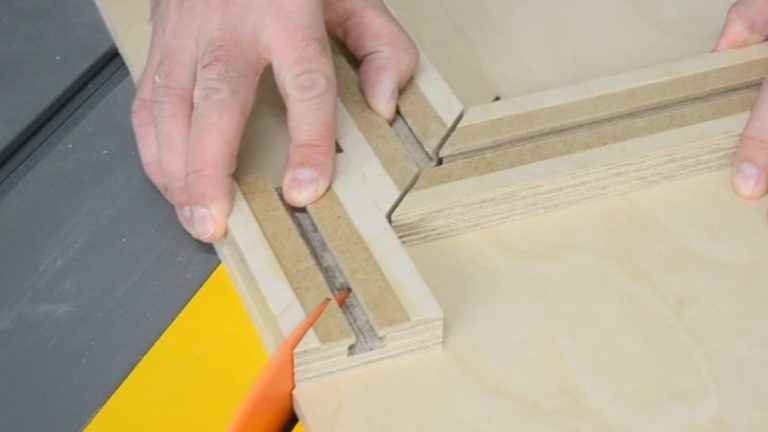 Fence offcut with a 45 degree end being reused as a stop block for the picture frame jig.