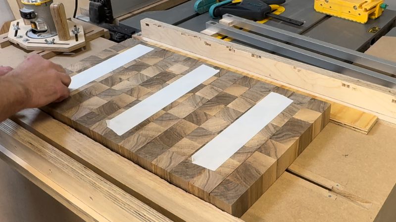 Shimming an attaching a cutting board blank inside a router flattening jig so it doesn’t rock before flattening.