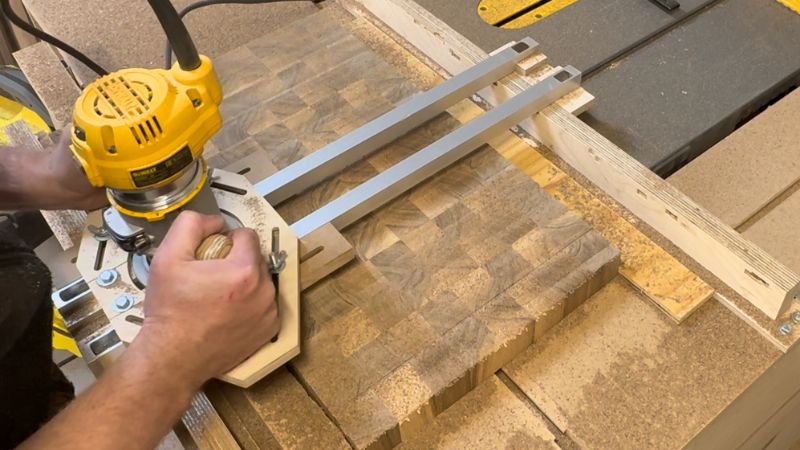 Router with a surfacing bit making a shallow flattening pass across a cutting board inside a router jig.