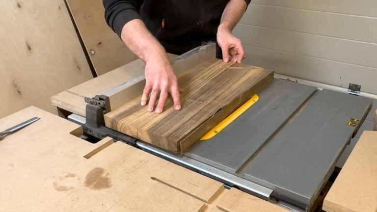 Cleaning one long edge of the walnut board by ripping it along the table saw fence.