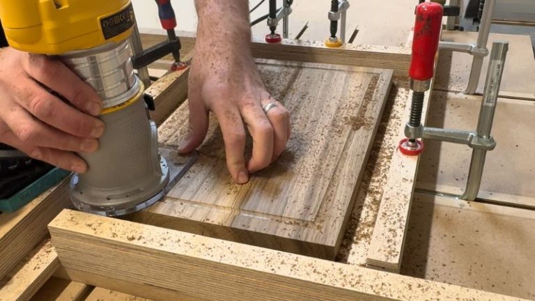 Routing a juice groove clockwise around the inside edge of a walnut cutting board.