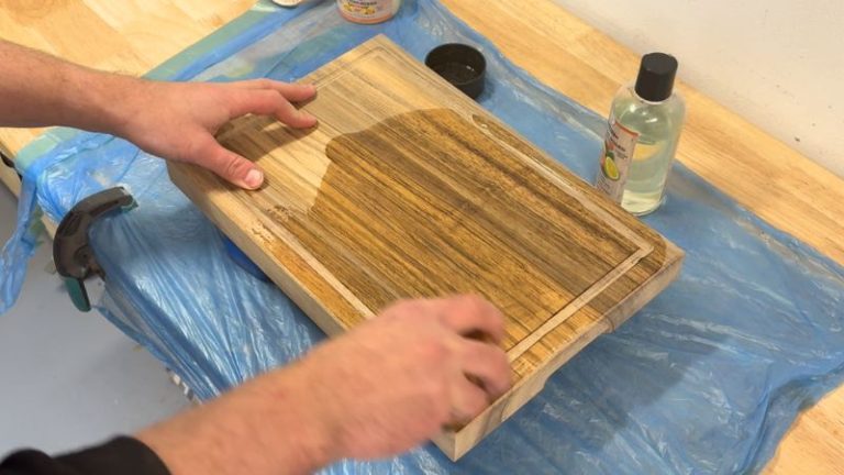 Applying Clark’s food-safe oil to a walnut cutting board to protect and deepen the color.