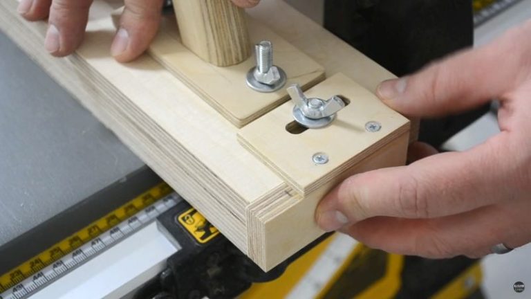 Adjusting the back stopper and hold-down clamp on the table saw thin strip jig before cutting.
