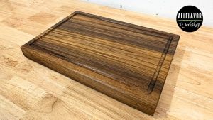 Walnut cutting board for beginners with juice groove, side handles, and rubber feet (simple face grain build).