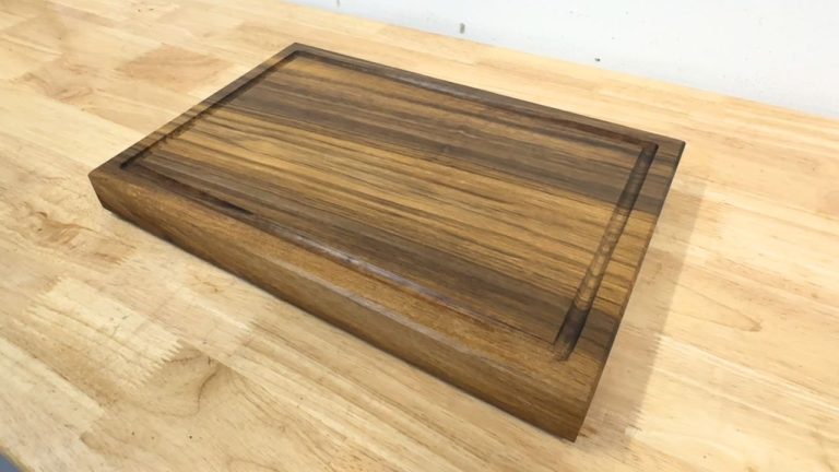 Walnut cutting board for beginners with rubber feet installed and a food-safe oil finish.