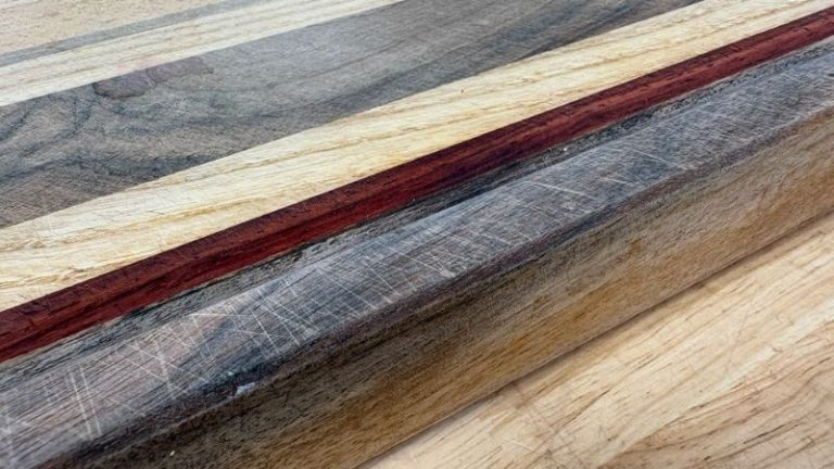 Close-up of heavy knife marks across an edge grain cutting board before refinishing.